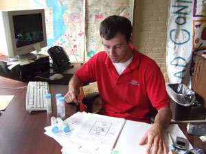male UNYSE team member sitting at desk reviewing asbestos samples
