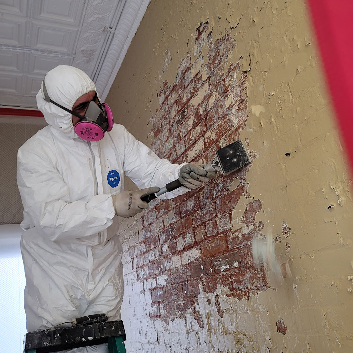 lead abatement in process, scrapping lead paint for removal